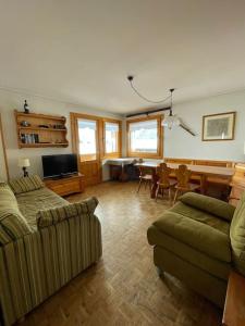 a living room with a couch and a table at Appartamento Rin, Livigno in Livigno