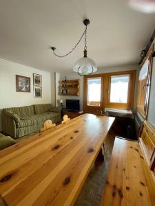 a living room with a wooden table and a couch at Appartamento Rin, Livigno in Livigno