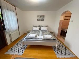 a bedroom with a bed in a room at Studio Apartman Sedrenik in Sarajevo