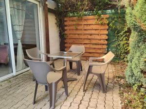 a table and chairs sitting on a patio at Gîte l'hirondelle in Flers-lez-Lille