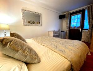 a bedroom with a bed and a mirror and a window at Domaine Des Médards in Beaulieu-sur-Loire