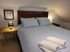 a bedroom with a large bed with a wooden headboard at Ballyrider House Beautiful Triple Suite in Inch Cross Roads