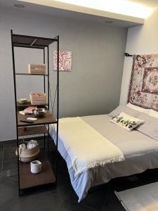 a room with a bed and a shelf next to it at Casa Roberto in Cefalù +12 photos