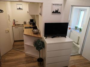 a small kitchen with a tv on a counter at City Center Old Town Studio in Innsbruck