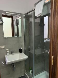a bathroom with a glass shower and a sink at Casa Roberto in Cefalù +13 photos