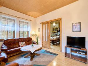 a living room with a leather couch and a table at Holiday Home Zlata Olesnice by Interhome in Zlatá Olešnice