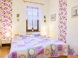 a bedroom with a bed with a purple comforter at Holiday Home Zlata Olesnice by Interhome in Zlatá Olešnice