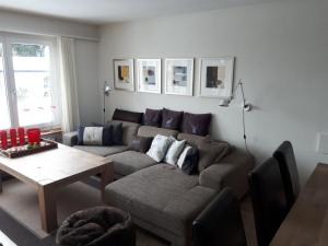 a living room with a couch and a table at Apartment Casa Selva Hauggaard by Interhome in Valbella