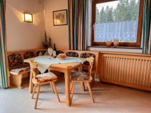 ein Esszimmer mit einem Tisch, Stühlen und einem Fenster in der Unterkunft Apartment App-1 by Interhome in Hollersbach im Pinzgau