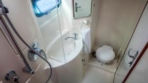 a small bathroom with a shower and a toilet at Sabba Whitesand Catamaran in Fodhdhoo