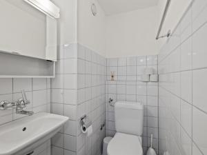 een witte badkamer met een toilet en een wastafel bij Apartment Nr-05 Haus Sursilvana by Interhome in Lenzerheide