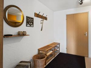 a room with a mirror and a wooden door at Apartment A302 by Interhome in Lenzerheide