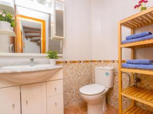 y baño con aseo, lavabo y espejo. en Holiday Home Gardenia by Interhome, en Cunit