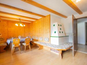 a dining room with a table and chairs and a cake at Holiday Home Plattner-2 by Interhome in Oetz