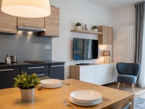 a kitchen with a dining table and a tv at Apartment Ski-In Ski-Out Mountain Duplex Portášky3 by Interhome in Pec pod Sněžkou