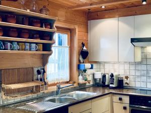 a kitchen with white cabinets and a sink and a window at Chalet Chalet Rodas 9 by Interhome in Malmigiuer