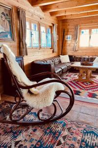 a bird sitting in a rocking chair in a living room at Chalet Chalet Rodas 9 by Interhome in Malmigiuer