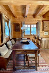 a dining room with a wooden table and chairs at Chalet Chalet Rodas 9 by Interhome in Malmigiuer