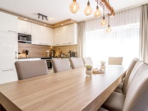 a kitchen and dining room with a wooden table and chairs at Holiday Home Lakeside Village 22 - - sauna by Interhome in Frymburk