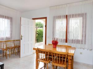 a dining room with a wooden table and chairs at Villa Villa Tello by Interhome in L'Ametlla de Mar +17 photos