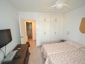 a bedroom with a bed and a flat screen tv at Apartment Formentor by Interhome in Salou