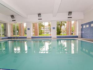 a swimming pool with blue water in a building at Apartment Aquaria-5 by Interhome in Salou