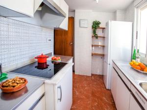 een keuken met witte kasten en een witte koelkast bij Apartment Ondina Plus by Interhome in Playa de Gandia