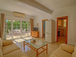 een woonkamer met een koelkast en een tafel bij Villa Mercedes by Interhome in Casas de Torrat