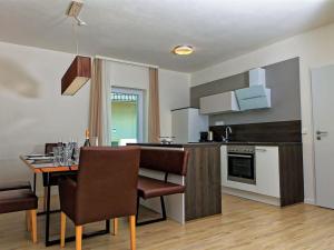 a kitchen and dining room with a table and chairs at Holiday Home Lakeside Village 23 - - sauna by Interhome in Frymburk