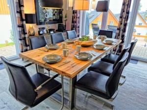 a dining room table with black chairs around it at Holiday Home Lakeside Village 36 - - sauna by Interhome in Frymburk