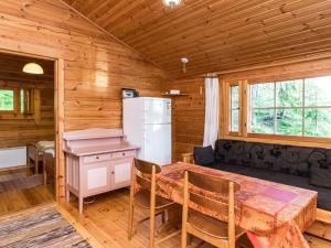 eine Küche und ein Esszimmer mit einem Tisch und einem Kühlschrank in der Unterkunft Holiday Home Lossitupa by Interhome in Iitti + 10 Fotos
