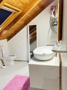 een witte badkamer met een toilet en een wastafel bij Villa La Roserie in Ducos