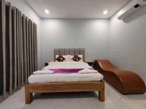 a bedroom with a bed and a chair at 83 Guesthouse in Bahal +15 photos