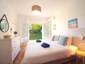 a bedroom with a large bed with two blue towels on it at Villa Mariana by Interhome in Galé