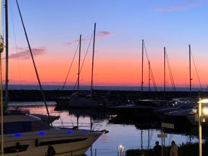 a group of boats docked in a marina at sunset at Apartment Ponente N-2 by Interhome in San Vincenzo