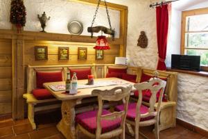 comedor con mesa y sillas rojas en Hölzlhaus - a74066, en Mittenwald