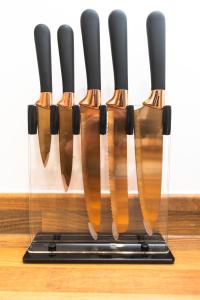 a group of knives in a holder on a counter at Leeds Lodge in Leeds