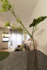 a vase with flowers in it sitting on a table at Modern Lakefront 1-Bedroom Apartment in Acquaseria
