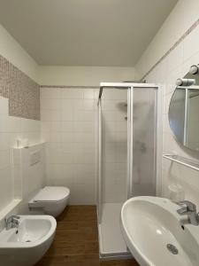 a bathroom with a toilet and a sink and a shower at Bait Panorama in Livigno