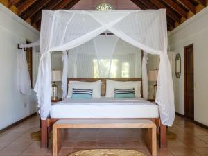 a bed in a room with a canopy bed at Gingerbread Suites in Port Elizabeth