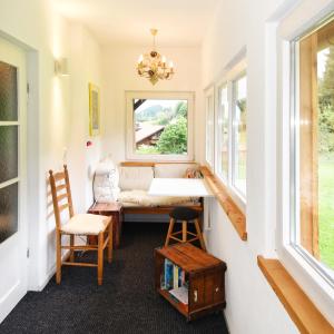 a room with a table and chairs and a window at Vogelmann Suite in Pfronten