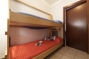 a bedroom with two bunk beds and a door at Lake View Apartment Studio Vacation Station in Acquaseria