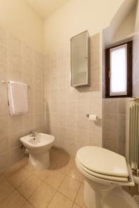 a bathroom with a toilet and a sink at Lake View Apartment Studio Vacation Station in Acquaseria