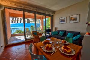 ein Wohnzimmer mit einem Tisch und einem Sofa in der Unterkunft 2-Bedroom Lakeview Apartment Bella Gaeta in San Siro