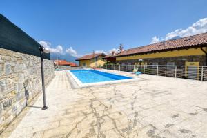 a swimming pool in front of a house at Bello Pianello Lake View Apartment in Pianello Del Lario