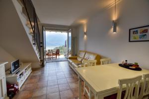 a living room with a couch and a table at Bello Pianello Lake View Apartment in Pianello Del Lario
