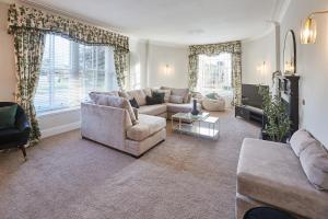 a living room with a couch and a tv at Silton Hall - Grade II Hall & Swimming Pool in Nether Silton +31 photos