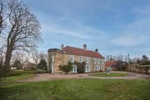 an old brick house with a red roof at Host & Stay - Silton Hall in Nether Silton