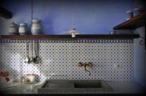 a bathroom with a sink and a tiled wall at Podere di Maggio - Casa della Nonna in Santa Fiora
