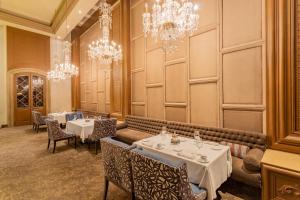 a dining room with tables and chandeliers at Quinta Real Monterrey in Monterrey